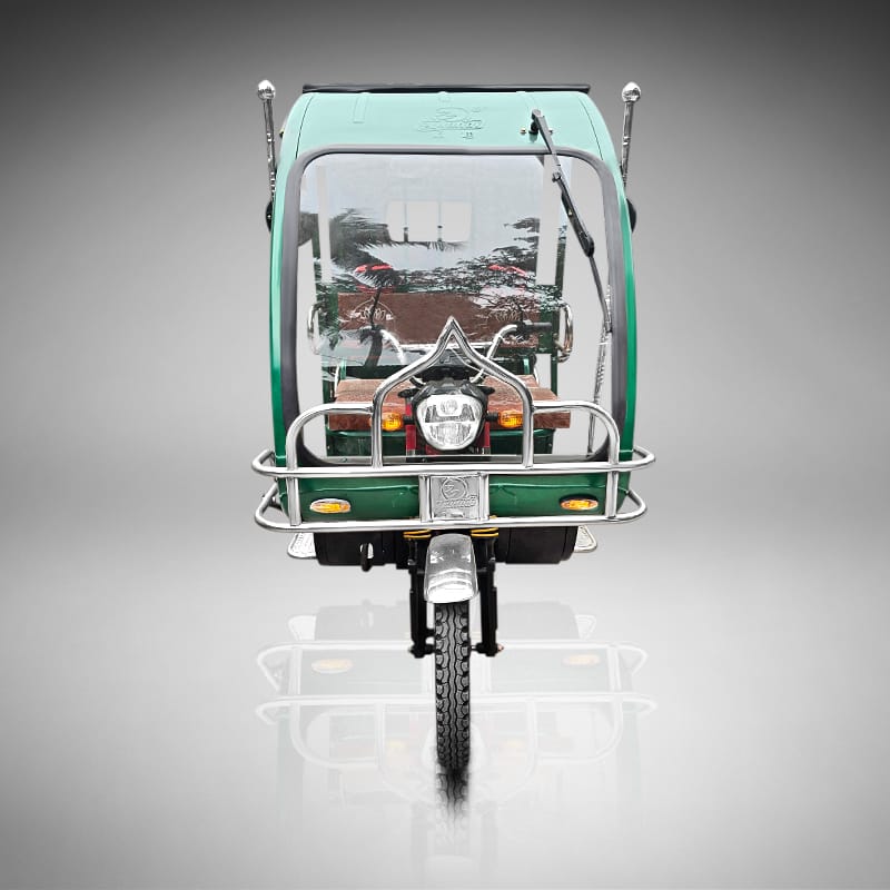 Front view of the green Borak auto rickshaw with LED headlight.