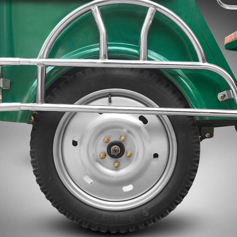 Heavy-duty rear wheel and tire of Borak auto rickshaw.